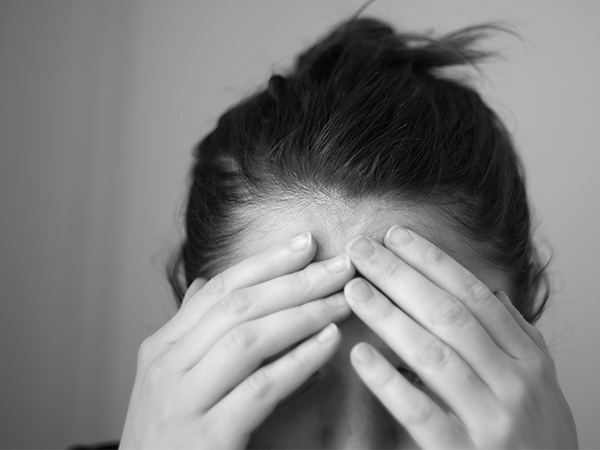 Stressed person holding head